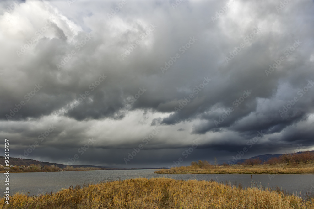 dark clouds river island.