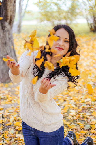 young beautiful girl in the forest. Warm autumn