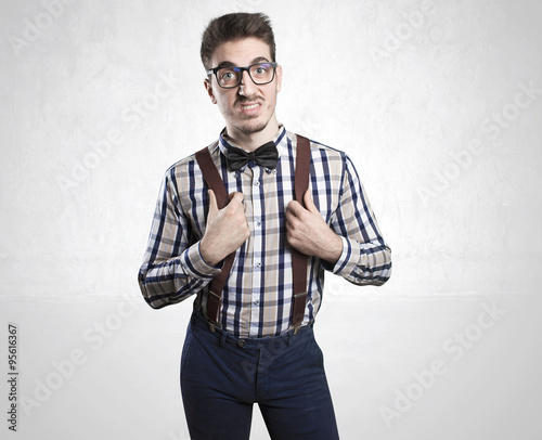 Funny portrait of young nerd with eyeglasses isolated on background