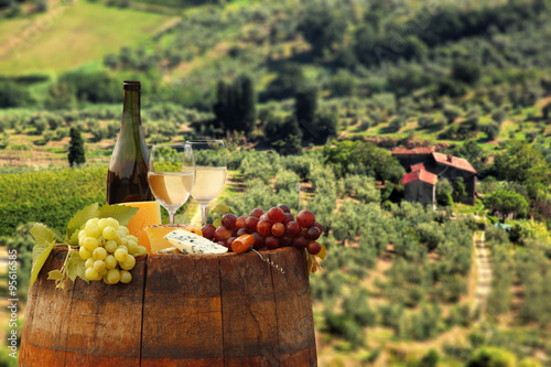 White wine with barrel on vineyard in Chianti, Tuscany, Italy photo