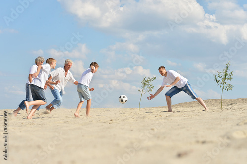Family playing footbal