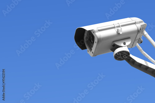 Security camera on blue sky background