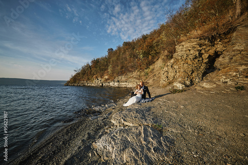 photoshoot lovers in a wedding dress in the mountains near the s