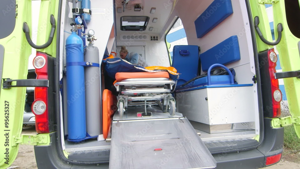 Emergency medical service female paramedic working in opened ambulance Emergency medical service female paramedic working in opened ambulance