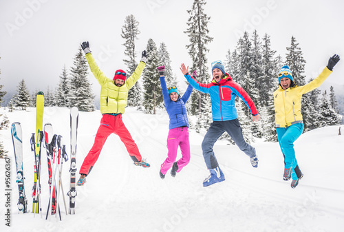 Group of skiers jumping and having fun