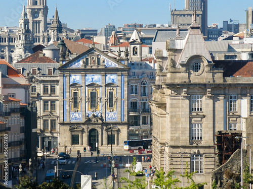 Building with azulejos tiles is Igreja dos Congregados. Building on the right is Sao Bento Station. Location: Praca de Almeida Garrett, Porto, Portugal photo