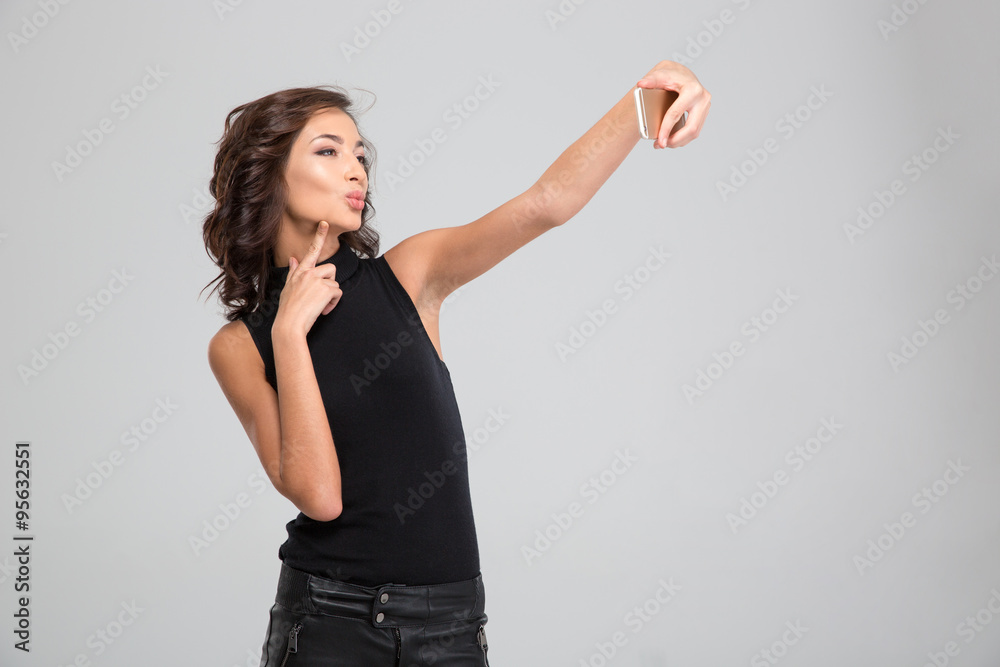 Beautiful young woman making selfie using cellphone Beautiful young woman making selfie using cellphone