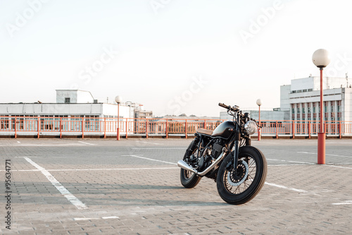 Motorbike on parking in city  with open sky on background