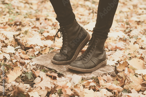 Girl in leather boots in the forest
