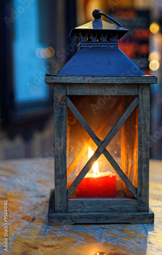 Vintage lantern with a burning candle