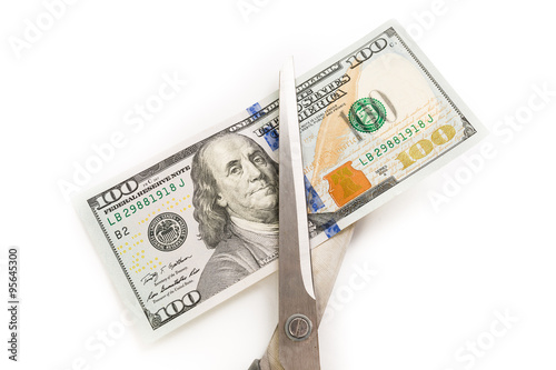 Dollars are cutting with scissors on a white background.