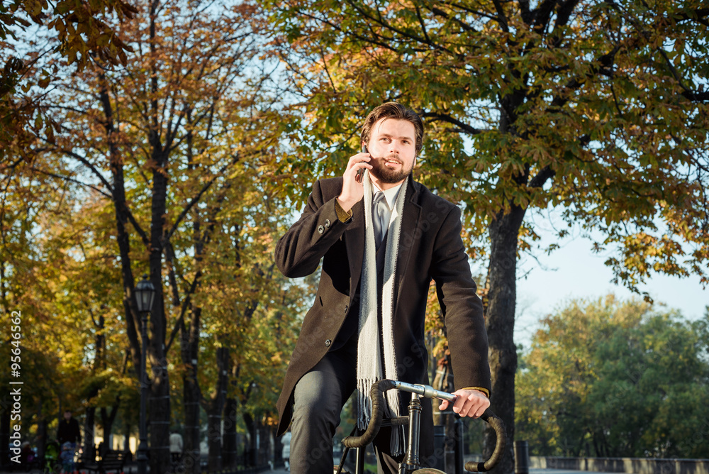 young caucasian businessman riding bicycle