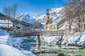 Idyllic mountain winter landscape with famous church and crystal clear river in Ramsau, Berchtesgadener Land, Bavaria, Germany