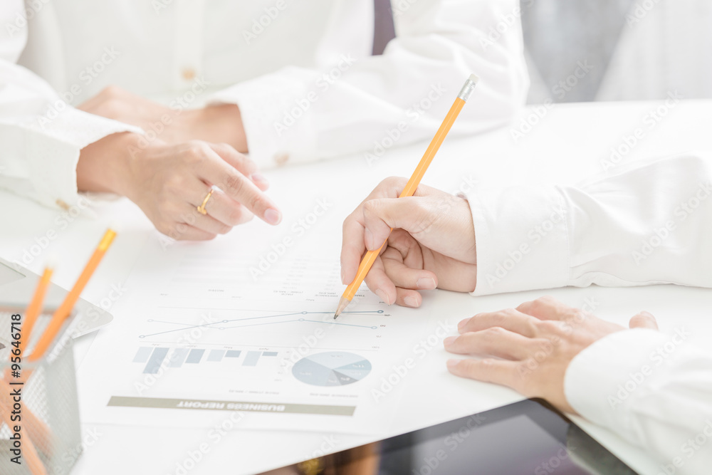 Business people discussing the charts and graphs showing the res Business people discussing the charts and graphs showing the res