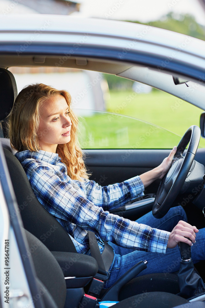Naklejka premium young woman driving a car