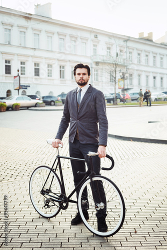 Fototapeta Naklejka Na Ścianę i Meble -  young caucasian businessman with bicycle