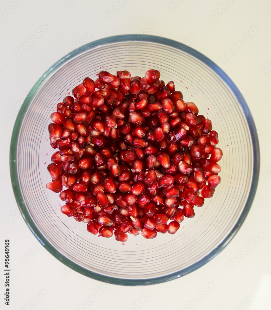 Pomegranate seeds, juicy fruit in a glass container. Pomegranate seeds, juicy fruit in a glass container.