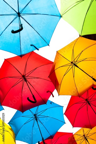 Many colorful umbrellas against the sky in city settings. Kosice, Slovakia. Color background