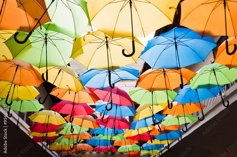 Obraz premium Street decoration with colorful open umbrellas hanging over the alley. Kosice, Slovakia