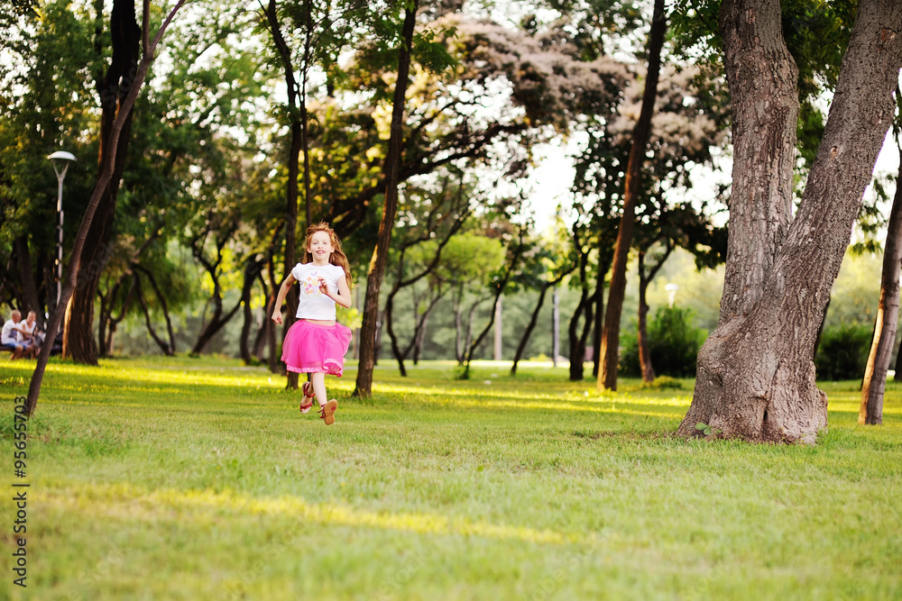 haired little girl runs across the grass haired little girl runs across the grass