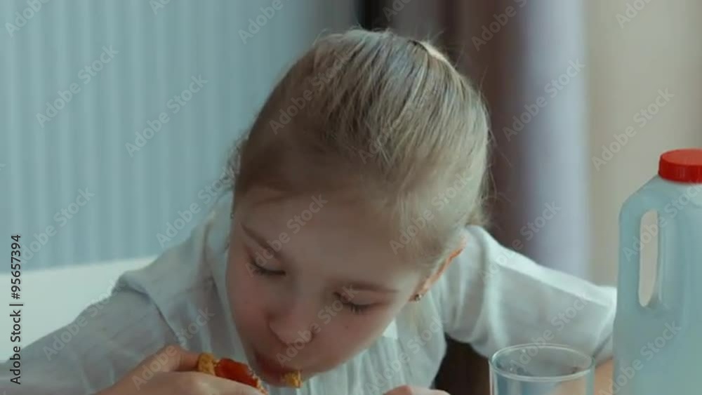 Closeup portrait laughing girl eating a cookie. Looking at camera and smiling Closeup portrait laughing girl eating a cookie. Looking at camera and smiling