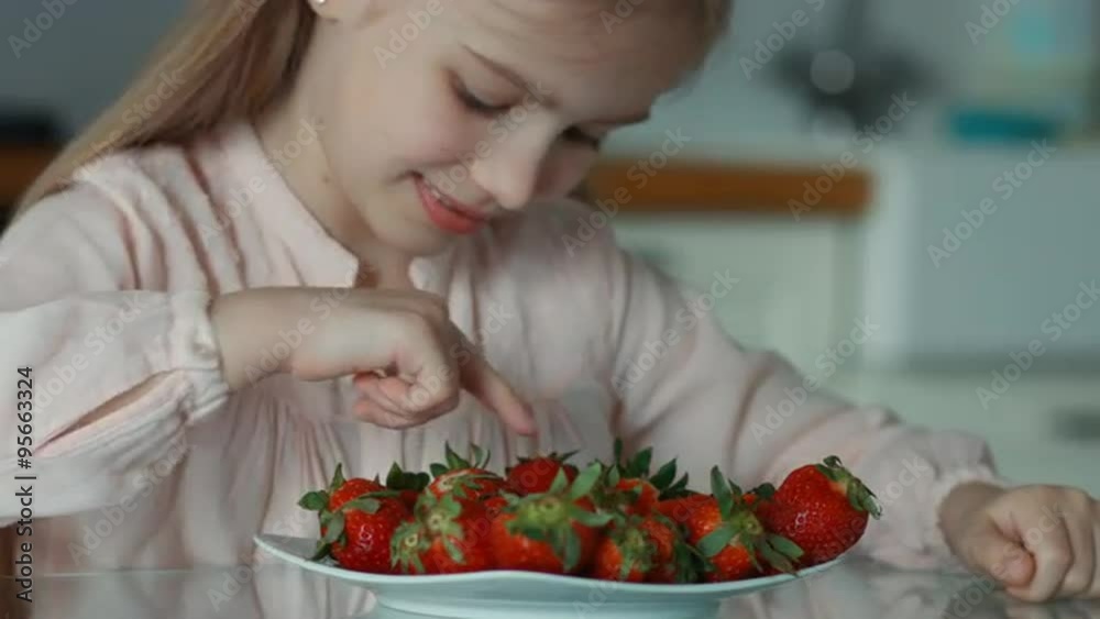 Closeup portrait little girl and a big plate of strawberries. Girl counting strawberries Closeup portrait little girl and a big plate of strawberries. Girl counting strawberries