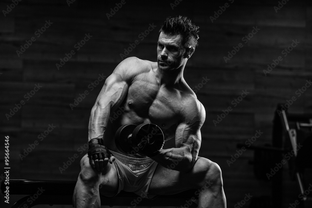 very power athletic guy bodybuilder , execute exercise with dumb