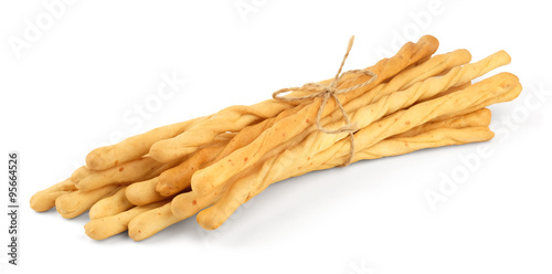 Quadro su tela Toasted wheat long bread sticks, tied with a rope, isolated on a white background