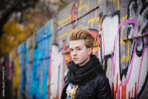 Fashion male portrait on graffiti wall © Voyagerix