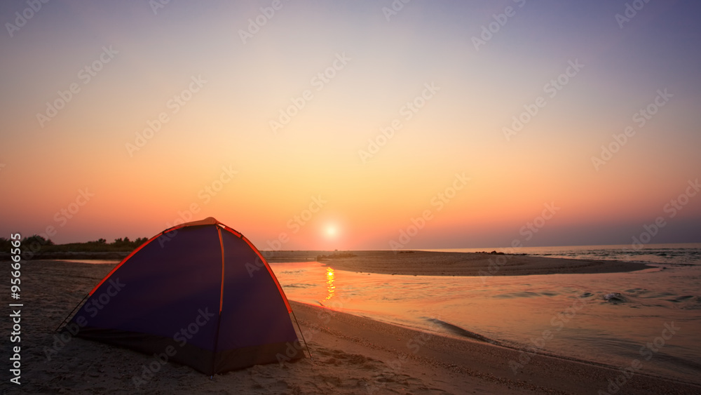 Camping on beach at sunset