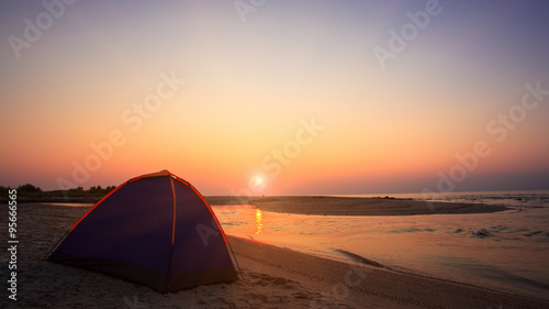Camping on beach at sunset