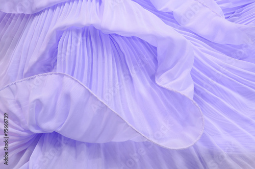 Close up on purple pleated lace. Pastel violet crumpled tulle as background. photo