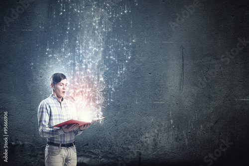 Close up of man holding opened book