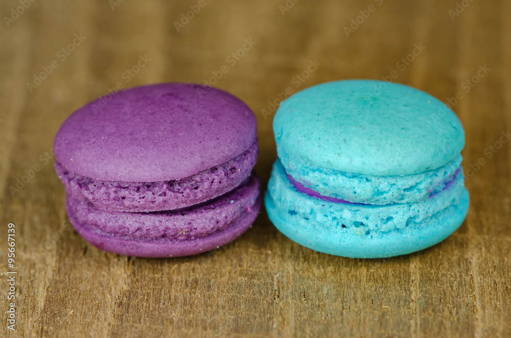 different kinds of macaroon placed on a wooden table different kinds of macaroon placed on a wooden table