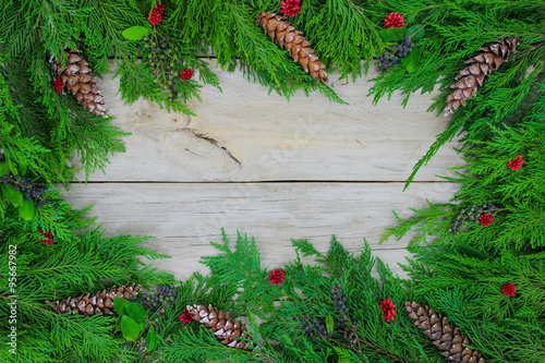 Christmas tree garland border with pine cones and berries