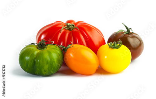 Different colors tomatos, Solanum lycopersicum, on white backgroung