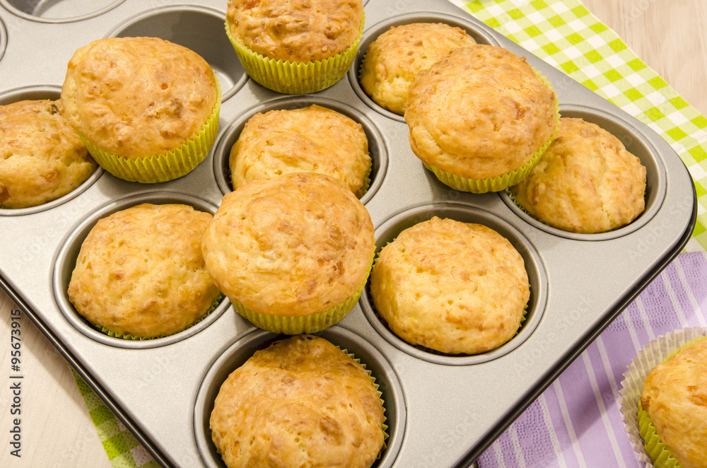 Muffins in a tray. Pile of muffins in a tin tray. Muffins in a tray. Pile of muffins in a tin tray.