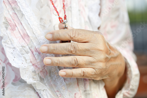 senior woman's hands in pray to buddha.