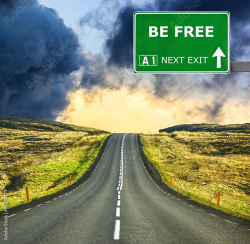 Fotografie BE FREE road sign against clear blue sky