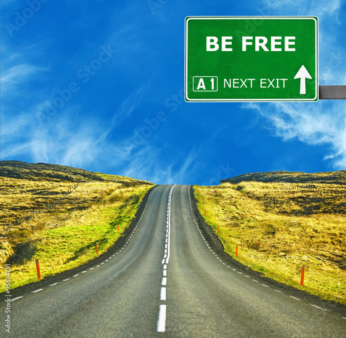 Fotografia BE FREE road sign against clear blue sky