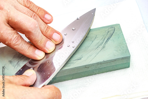 Honing Chef Knife/Close up of hand working Japanese chef knife 