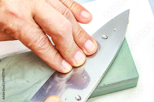 Honing Chef Knife/Close up of hand working Japanese chef knife 