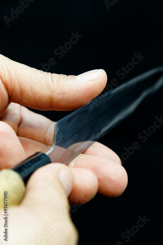 Honing Chef Knife/Close up of hand working Japanese chef knife 