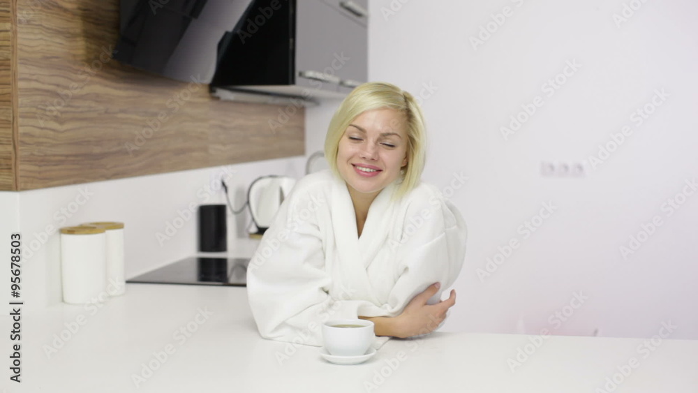 Woman happy smile, morning beautiful young girl wear white bathrobe in kitchen Woman happy smile, morning beautiful young girl wear white bathrobe in kitchen