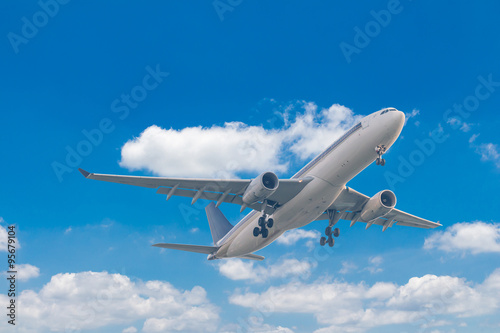 Commercial airplane flying with blue sky background