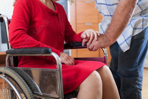 woman in wheelchair and elderly man