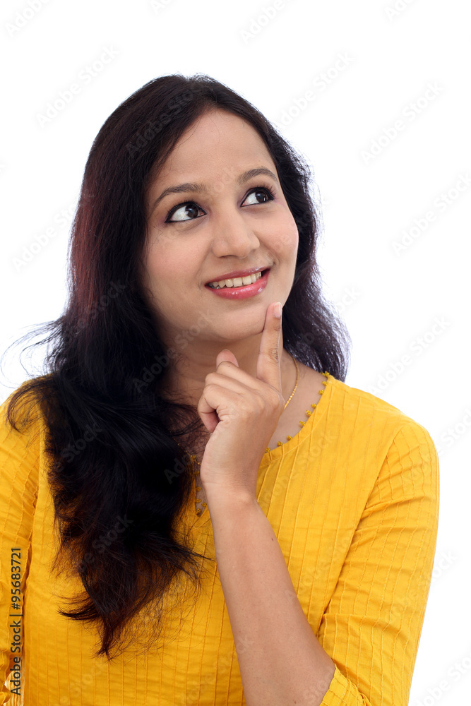 Happy young woman thinking against white background Happy young woman thinking against white background