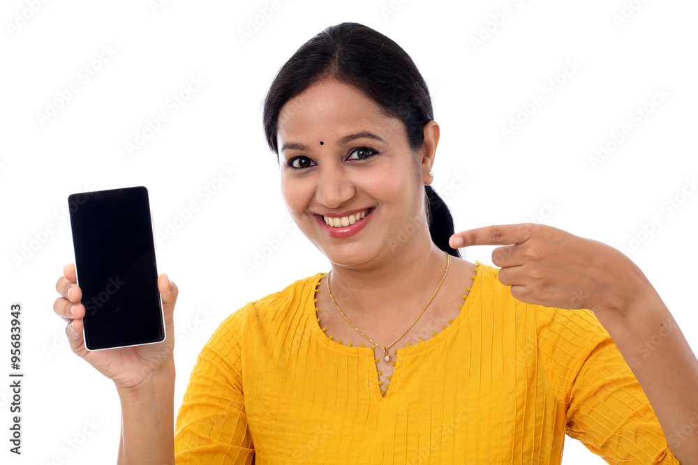 Cheerful woman pointing finger on smartphone screen Cheerful woman pointing finger on smartphone screen