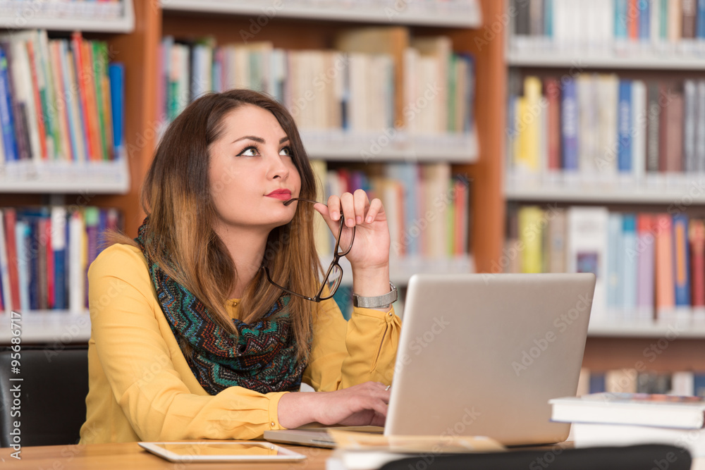 Confused Female Student Reading Many Books For Exam Confused Female Student Reading Many Books For Exam