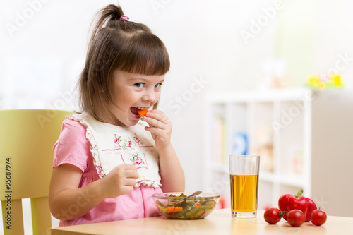 child little girl eating he...